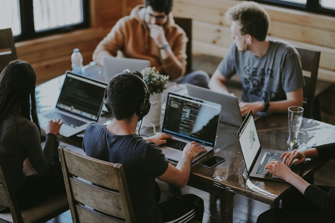 Technology team collaborating around a computer in an office